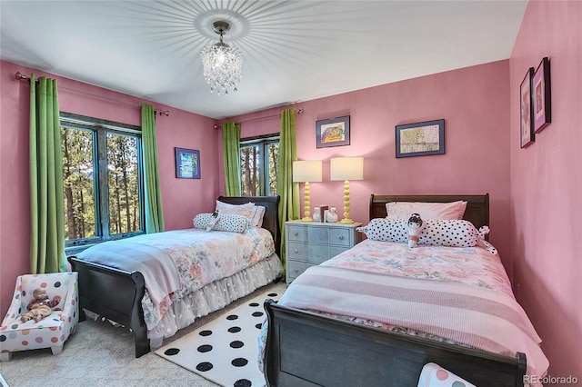 carpeted bedroom with an inviting chandelier