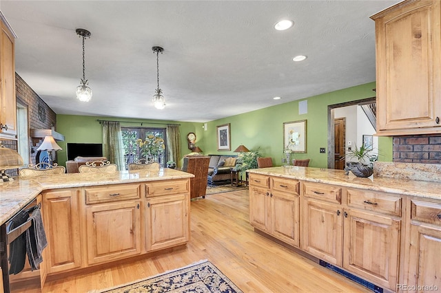 kitchen featuring pendant lighting, light brown cabinetry, light stone countertops, a textured ceiling, and light hardwood / wood-style flooring