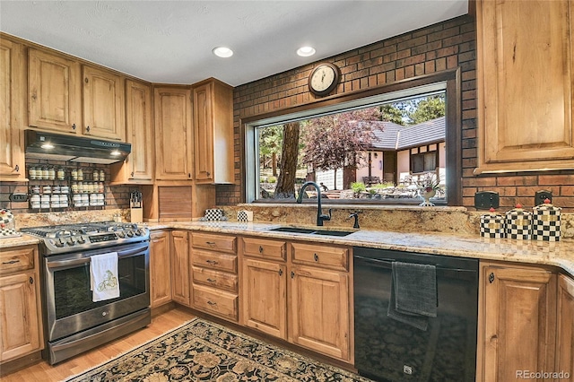 kitchen with sink, stainless steel gas range, light hardwood / wood-style flooring, dishwasher, and light stone counters