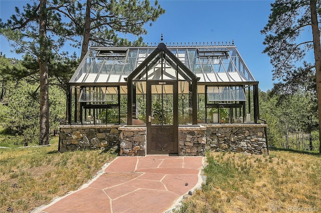 back of property with an outdoor structure