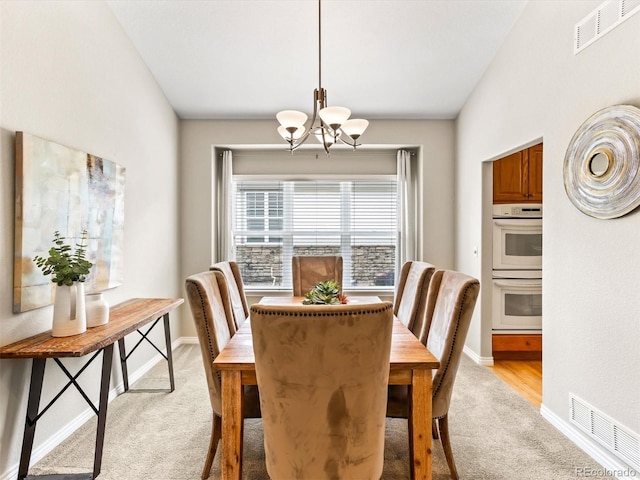 1836 S Kendall Ct, Lakewood, CO 80232 - dining space with light colored carpet, a chandelier, and baseboards