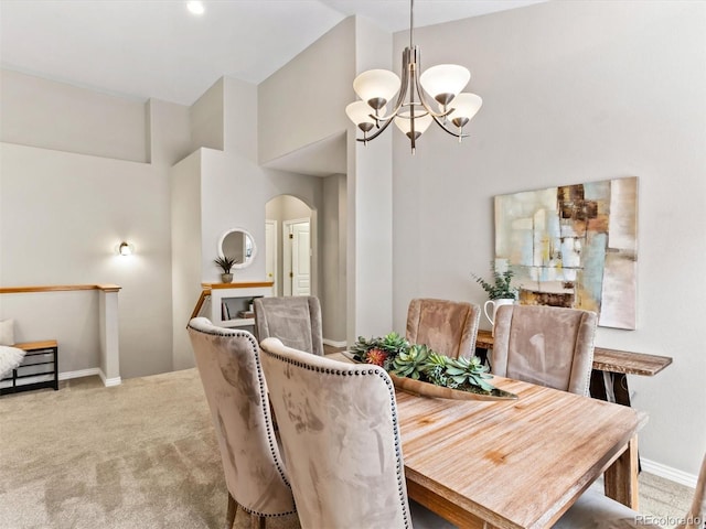 1836 S Kendall Ct, Lakewood, CO 80232 - dining area with arched walkways, a chandelier, carpet, high vaulted ceiling, and baseboards