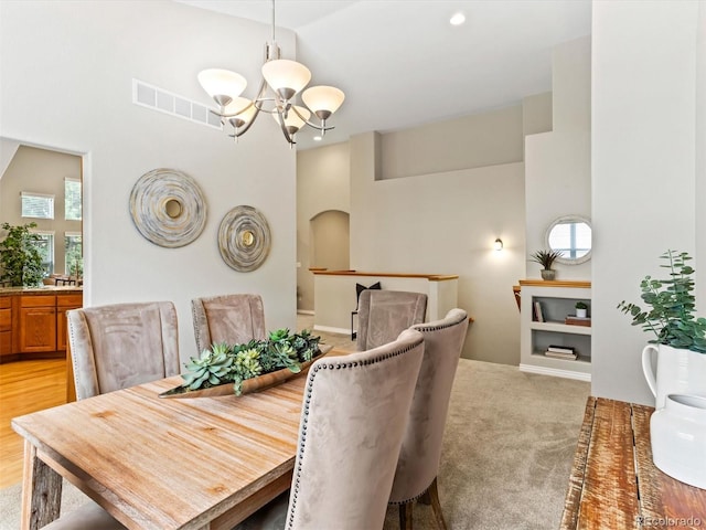 1836 S Kendall Ct, Lakewood, CO 80232 - dining space with a chandelier, plenty of natural light, arched walkways, a high ceiling, and recessed lighting