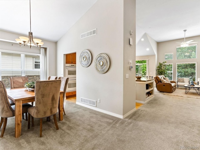 1836 S Kendall Ct, Lakewood, CO 80232 - dining area with light colored carpet, a chandelier, baseboards, high vaulted ceiling, and ceiling fan