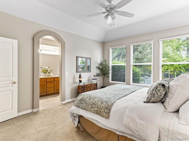 1836 S Kendall Ct, Lakewood, CO 80232 - bedroom with light colored carpet, baseboards, ensuite bathroom, arched walkways, and ceiling fan