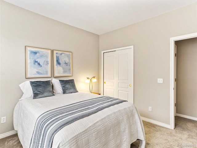 1836 S Kendall Ct, Lakewood, CO 80232 - bedroom featuring light colored carpet, baseboards, and a closet
