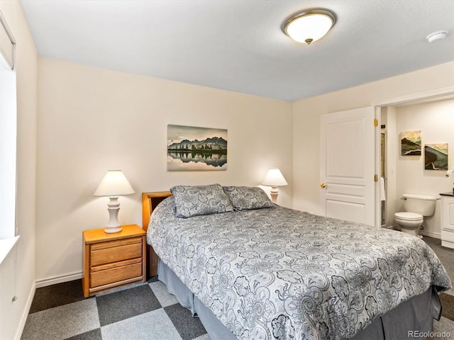 1836 S Kendall Ct, Lakewood, CO 80232 - bedroom with dark carpet, baseboards, and ensuite bath