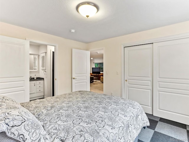 1836 S Kendall Ct, Lakewood, CO 80232 - bedroom with a closet, ensuite bath, and dark floors