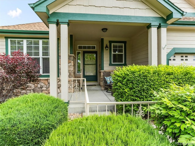 1836 S Kendall Ct, Lakewood, CO 80232 - doorway to property featuring a porch, a shingled roof, and stone siding