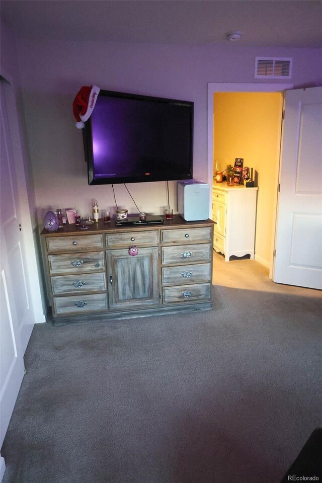 unfurnished living room with carpet flooring and visible vents