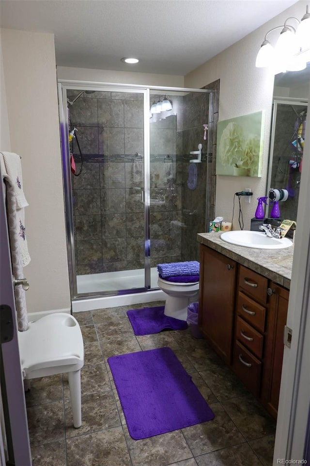 full bath with toilet, a stall shower, and vanity