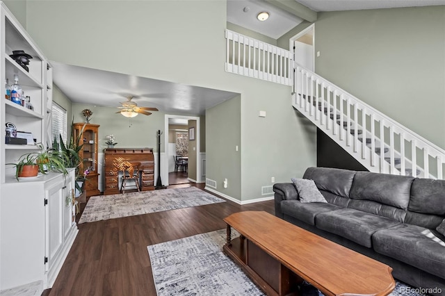 living room with hardwood / wood-style flooring, high vaulted ceiling, ceiling fan, and beam ceiling