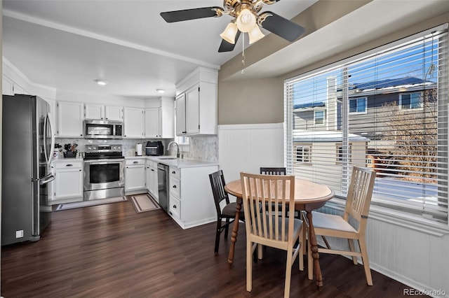 kitchen featuring sink, white cabinets, decorative backsplash, stainless steel appliances, and dark wood-type flooring