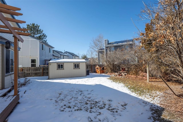 snowy yard featuring an outdoor structure