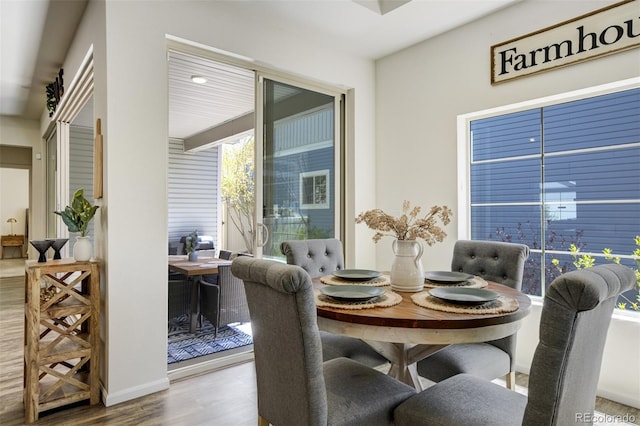 dining area with wood finished floors