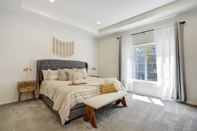 bedroom featuring carpet, recessed lighting, a tray ceiling, and baseboards