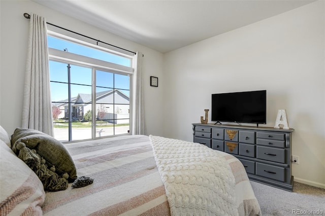 bedroom with carpet and baseboards