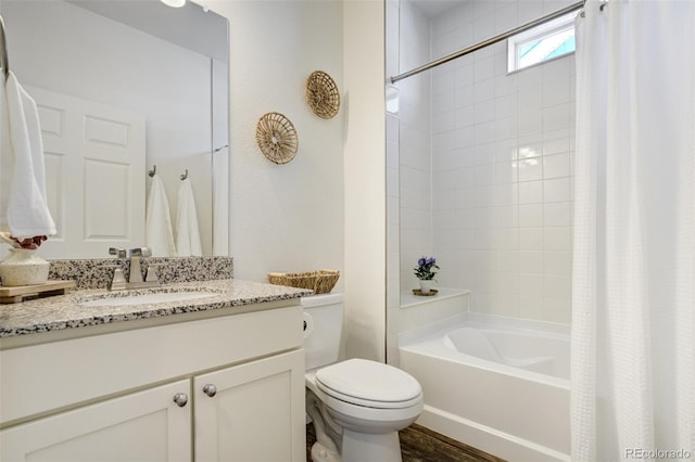 full bathroom with toilet, shower / bath combo with shower curtain, and vanity