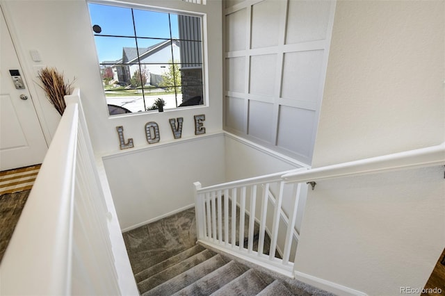 stairway featuring carpet flooring