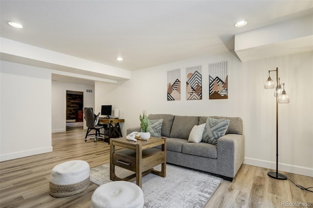 living room with wood finished floors, an office area, baseboards, and recessed lighting