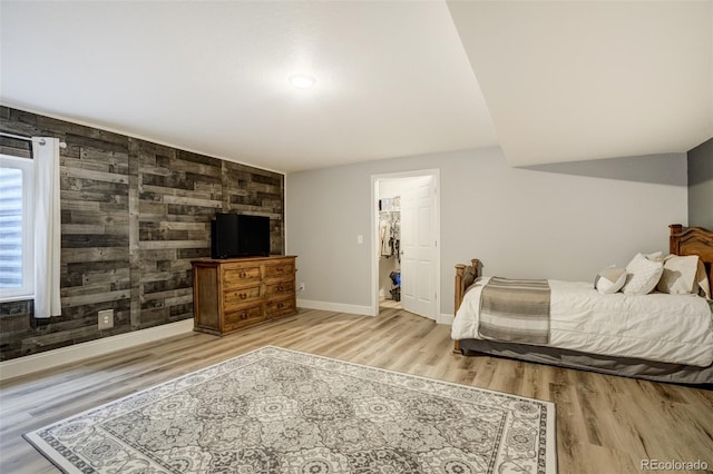 bedroom with wood finished floors and baseboards