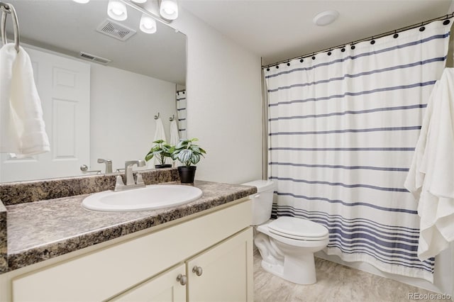 full bath featuring toilet and vanity