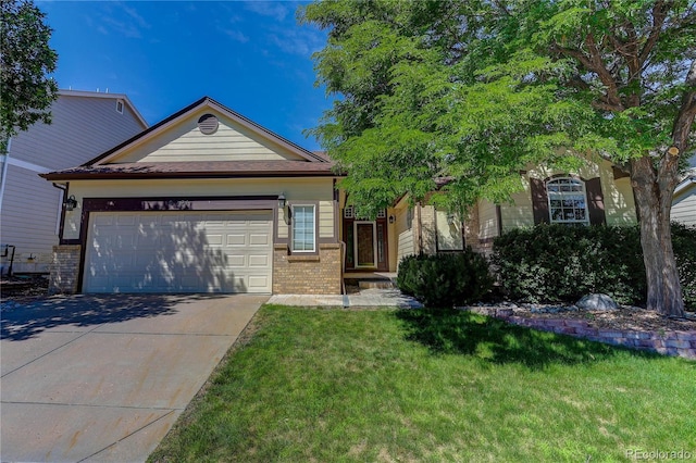 8651 Mallard Pl, Highlands Ranch, CO 80126 - view of front facade with brick siding, driveway, a front lawn, and an attached garage