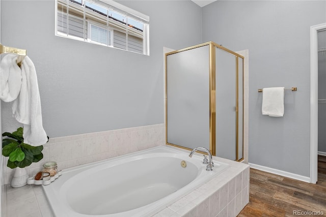 8651 Mallard Pl, Highlands Ranch, CO 80126 - bathroom featuring a garden tub, a stall shower, and wood finished floors