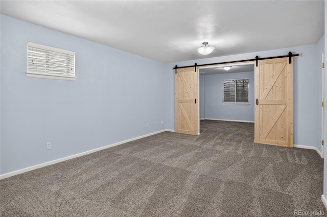 8651 Mallard Pl, Highlands Ranch, CO 80126 - unfurnished room with a barn door and dark carpet