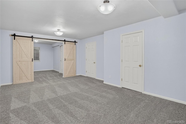 8651 Mallard Pl, Highlands Ranch, CO 80126 - unfurnished bedroom featuring a barn door and carpet