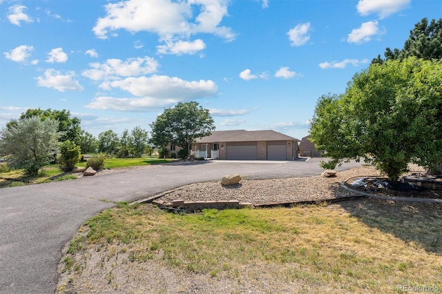 single story home with a garage and a front yard