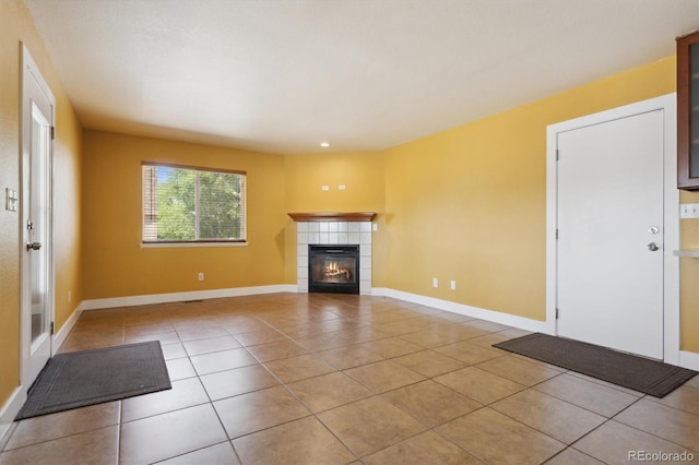 unfurnished living room with light tile patterned floors and a fireplace