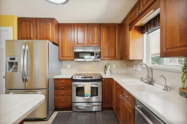 kitchen featuring stainless steel appliances, sink, and decorative backsplash