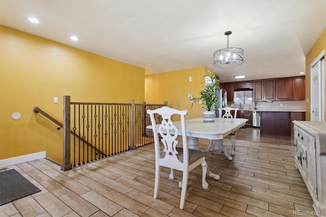 dining area with a notable chandelier and sink