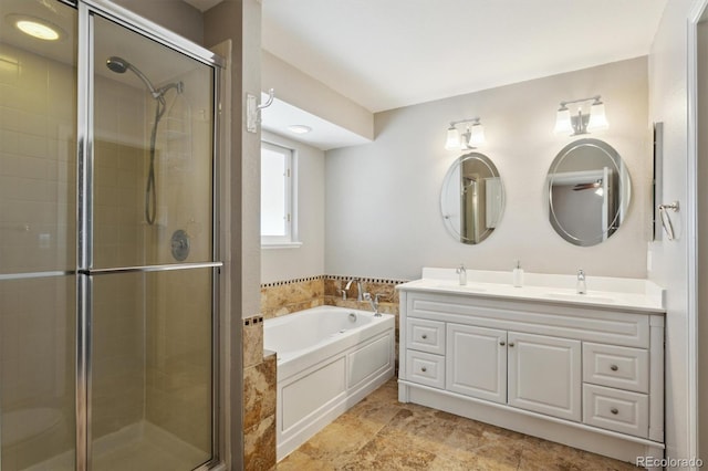 bathroom featuring plus walk in shower and vanity