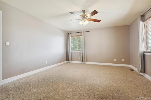 carpeted empty room featuring ceiling fan