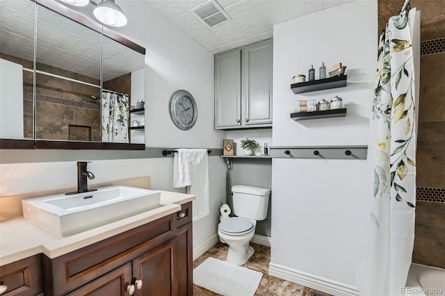 bathroom with visible vents, baseboards, toilet, vanity, and curtained shower