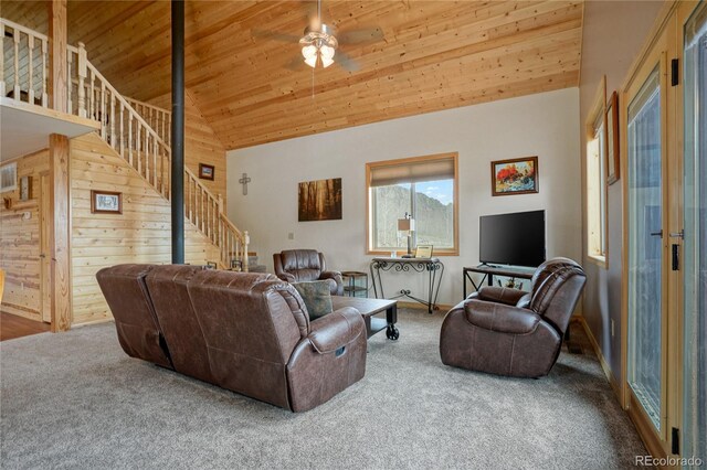 16395 Meadow Dr, Walsenburg, CO 81089 - carpeted living area with stairway, high vaulted ceiling, a ceiling fan, wooden walls, and wooden ceiling