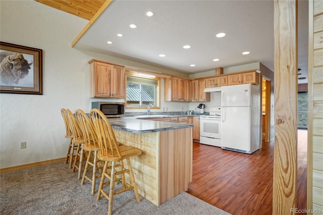 16395 Meadow Dr, Walsenburg, CO 81089 - kitchen with a peninsula, white appliances, recessed lighting, and a sink