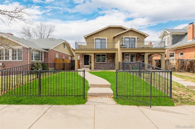 1653 S Logan St, Denver, CO 80210 - view of front of house with a balcony, a fenced front yard, a gate, stucco siding, and brick siding