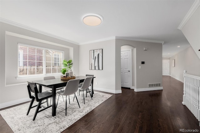 1653 S Logan St, Denver, CO 80210 - dining room with crown molding, dark wood-style floors, arched walkways, and recessed lighting