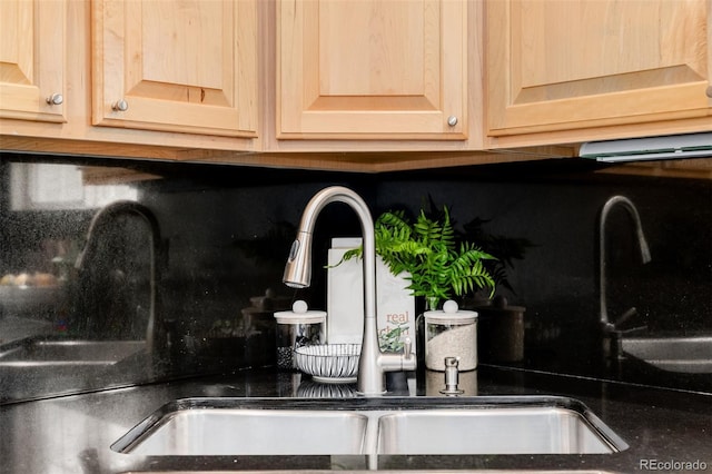 1653 S Logan St, Denver, CO 80210 - kitchen view of tasteful backsplash, light brown cabinets, and dark countertops