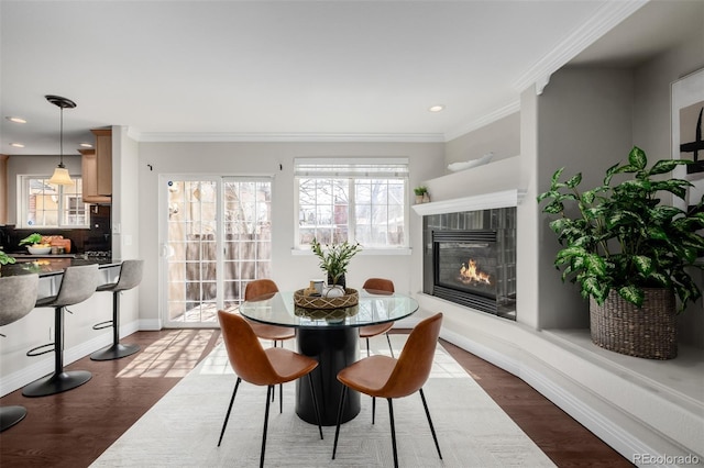 1653 S Logan St, Denver, CO 80210 - dining space featuring a glass covered fireplace, recessed lighting, dark wood finished floors, and crown molding