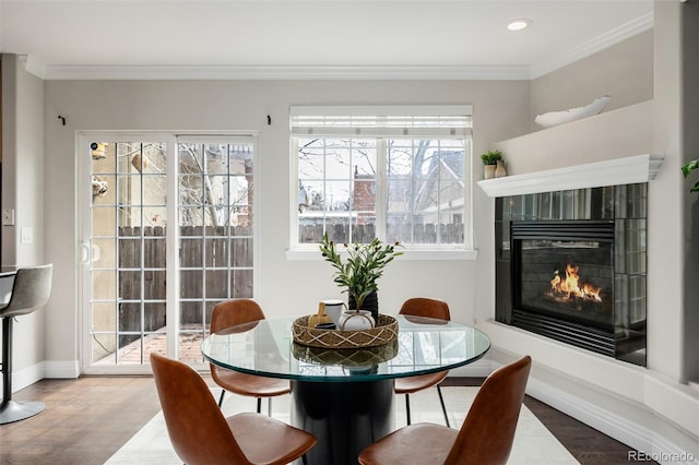 1653 S Logan St, Denver, CO 80210 - dining room featuring a tile fireplace, wood finished floors, ornamental molding, and recessed lighting