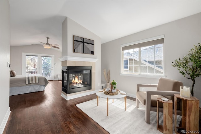 1653 S Logan St, Denver, CO 80210 - living room featuring vaulted ceiling, wood finished floors, a multi sided fireplace, and a ceiling fan