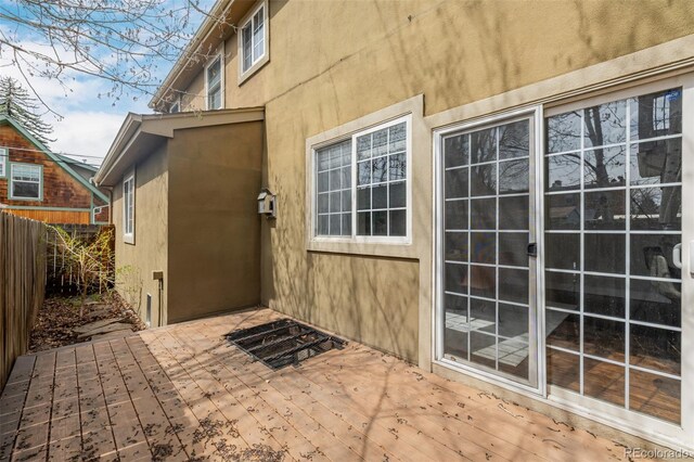 1653 S Logan St, Denver, CO 80210 - entrance to property featuring a wooden deck and stucco siding