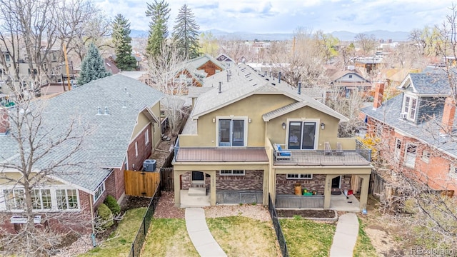 1653 S Logan St, Denver, CO 80210 - view of front of home with stucco siding, a residential view, and a balcony