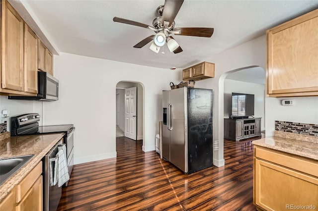 kitchen featuring ceiling fan, appliances with stainless steel finishes, light brown cabinetry, and dark hardwood / wood-style flooring