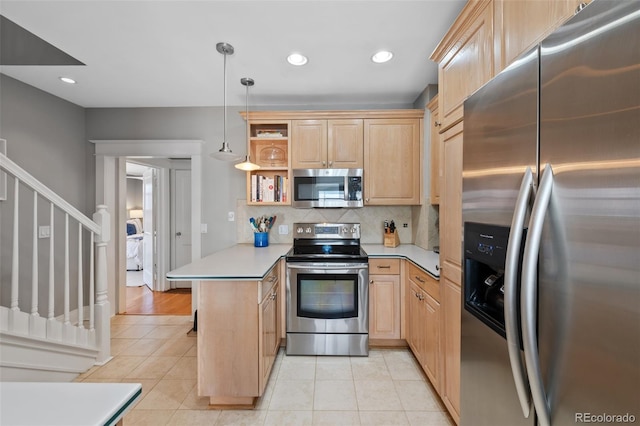 kitchen featuring a peninsula, appliances with stainless steel finishes, open shelves, and light brown cabinetry