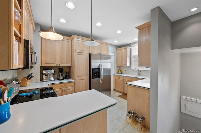 kitchen featuring a sink, electric range oven, light brown cabinets, and stainless steel fridge with ice dispenser